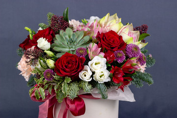 floral fresh arrangement of bright flowers in a hat box gray background copy space
