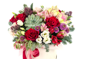 floral fresh arrangement of bright flowers in a hat box copy space white background