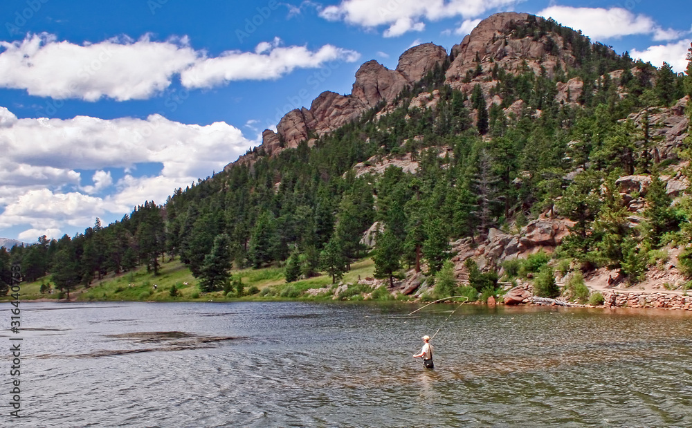 Wall mural fly fisherman in lily lake, rocky mountain national park, colorado