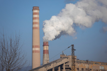 Smoking chimney and electric pole,