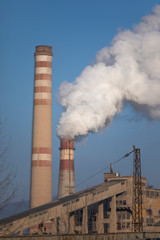 Smoking chimney and electric pole,