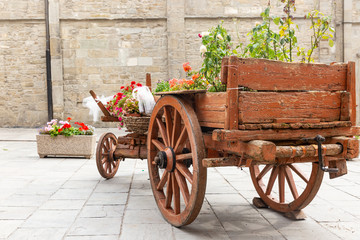 an old wooden chariot decorated with flowers