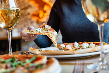 woman eating pizza in the cafe