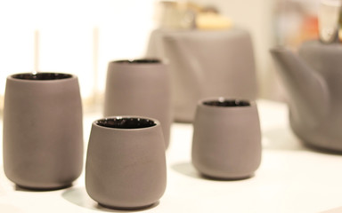 Tea sets in the store. Cups in gray color
