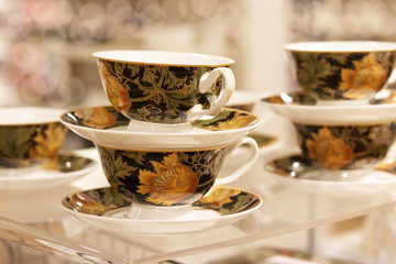 Tea sets in the store. Cups and saucers