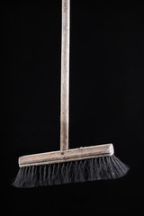 Old dusty wooden broom. Cleaning accessories.