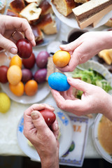 The family holds Easter eggs in their hands for the Easter breakfast