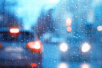Fototapeta na wymiar drops on glass auto road rain autumn night / abstract autumn background in the city, auto traffic, romantic trip by car