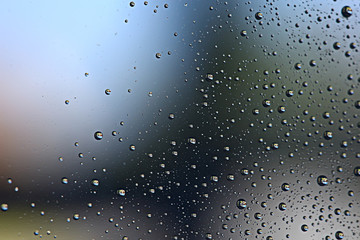 gray wet background / raindrops to overlay on the window, weather, background drops of water rain on the glass transparent