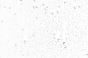 white isolated background water drops on the glass / wet window glass with splashes and drops of...
