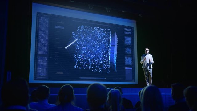 Computer Science Startup Conference: On Stage Speaker Does Presentation of New Product, Talks about Neural Networks, Shows New AI, Big Data and Machine Learning App on Big Screen. Live Event