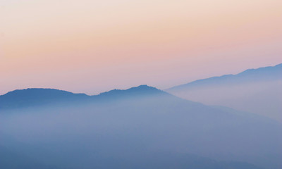 Fototapeta na wymiar View of the mist-covered mountains.