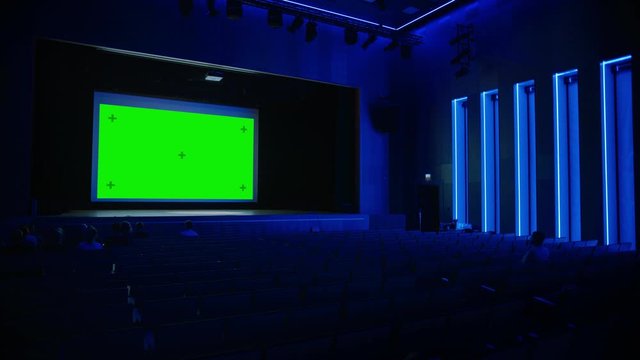 In Movie Theater Captivated Audience Watching New Blockbuster Film on Mock-up Green Screen. People Watching Video Game Tournament Streaming, Live Concert Video, New Product Release Trailer. Arc Shot