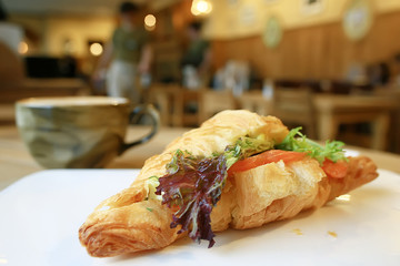 breakfast in a French cafe / croissant with salmon and salad for breakfast in a restaurant