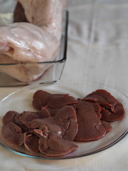 Carcass of raw rabbit meat on a glass baking sheet. Home cooking, cook at home.
