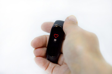 Fototapeta premium hand with fitness bracelet on a white background