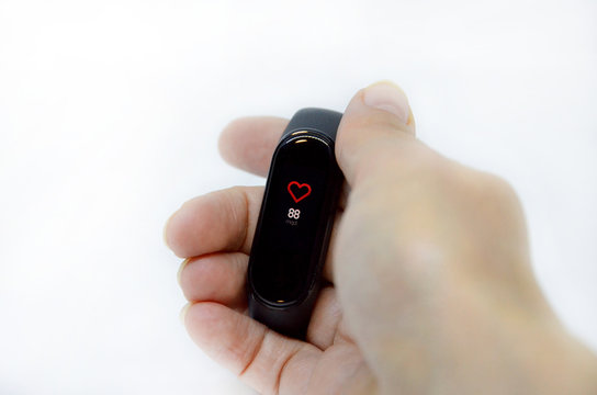 hand with fitness bracelet on a white background