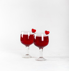 Cherry-strawberry drink, cocktail with jelly marmalade hearts on a white background