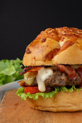Bacon Cheese Burger with tomato, lettuce and a drop of mayonnaise.