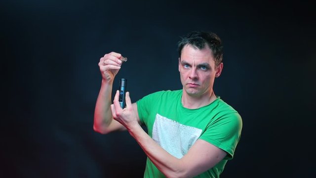 A man demonstrates detaching a vaporizer tube.