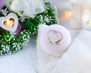 Obraz na płótnie Canvas Close up pink bath ball with roses, heart, towel on light background. Romantic spa lifestyle concept for Valentines day, Mothers day or wedding greeting card.
