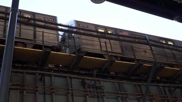 Slow motion shot of subway train passing. Long Island City, Queens, New York City, USA.