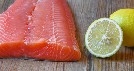 Fresh raw salmon fillet on a wooden background. Selective focus.