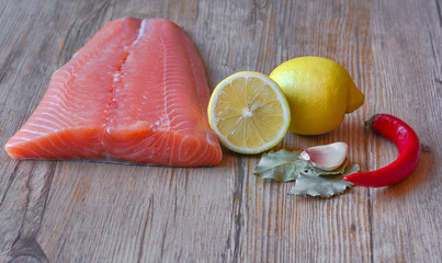 Fresh raw salmon fillet on a wooden background. Selective focus.