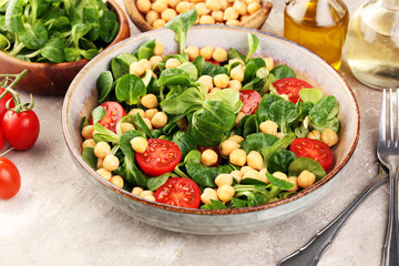 chickpea salad with ingredient and tomatoes and lamb´s lettuce. healthy salad