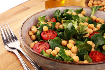 chickpea salad with ingredient and tomatoes and lamb´s lettuce. healthy salad