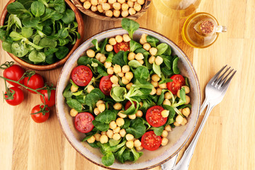 chickpea salad with ingredient and tomatoes and lamb´s lettuce. healthy salad