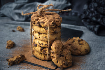 Close-up of handmade chocolate cookie tower tied with rope. Cooking background