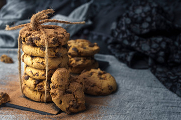 Close-up of handmade chocolate cookie tower tied with rope. Cooking background