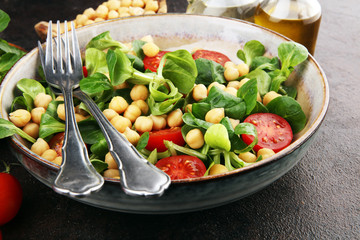 chickpea salad with ingredient and tomatoes and lamb´s lettuce. healthy salad