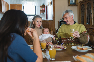 Happy grandparents enjoying with their granddaughter