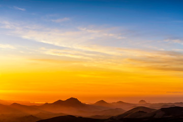 Fototapeta na wymiar Silhouette Mountains at Sunset from View