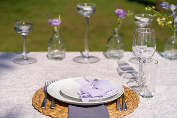 The festive table is served and decorated with fresh flowers. Details of festive decorations with fresh flowers