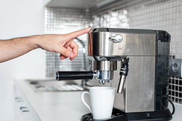 First-person view of a girl preparing delicious aromatic coffee in a coffee machine. A simple way to make coffee