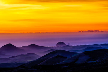 Layers of Clouds at Sunset over Silhouetted Mountains