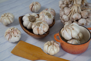 Garlic is placed on the white table in the kitchen, preparing for cooking,