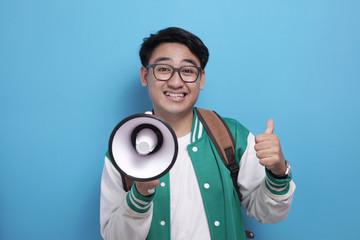Young Asian Male Student With Megaphone Advertisement Concept, Smiling Expression