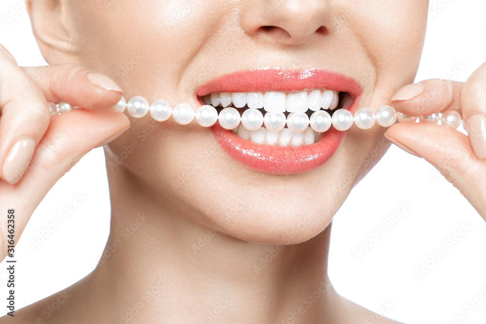 Wall mural beautiful female teeth smile and pearl necklace, dental health concept teeth whitening. dental clini