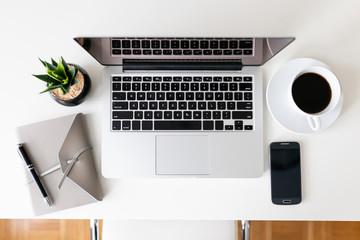 Overhead shot of desktop with open Laptop, notebook, mobile 