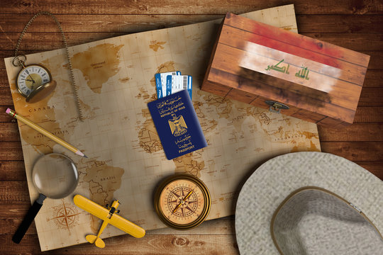 Top view of traveling gadgets, vintage map, magnify glass, hat and airplane model on the wood table background. On center, official passport of Iraq and your flag.