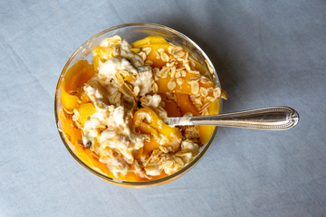 Mango with yogurt, muesli cereals and pistachio
