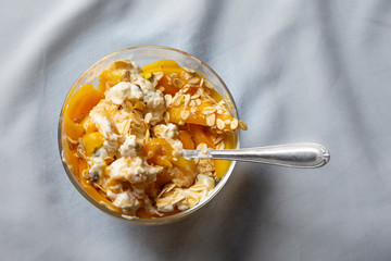 Mango with yogurt, muesli cereals and pistachio