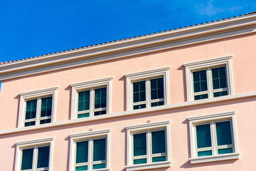 Exterior view of typical new mid-rise multifamily residential building without balcony. The buildings are usually rental apartments, college dorms, condominiums, assisted-living facilities