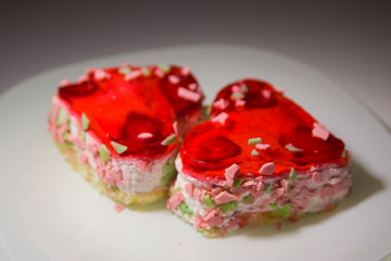 two heart-shaped cakes with berry filling on a white plate close-up