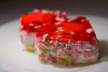 two heart-shaped cakes with berry filling on a white plate close-up