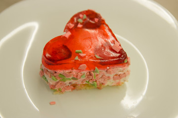 heart-shaped cake with berry filling on a white plate close-up